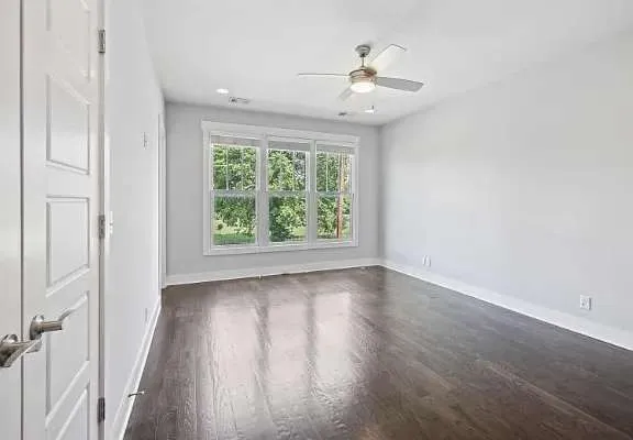 wooden floor in an empty room with a window