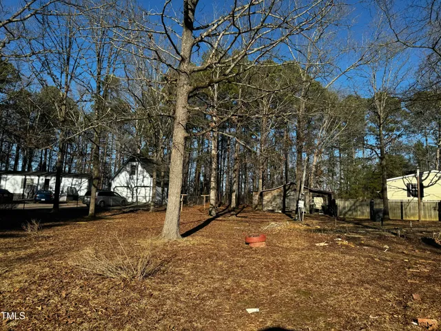 a view of a yard with a tree