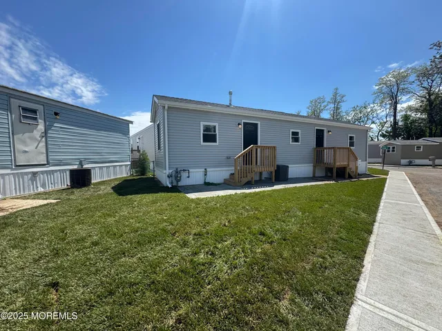 a view of a house with backyard and sitting area