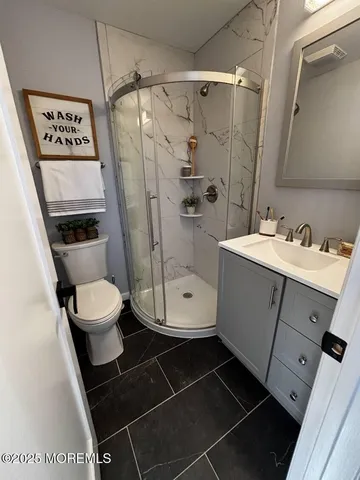 a bathroom with a toilet a sink and shower