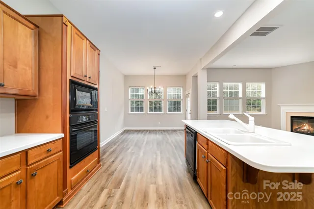 a kitchen with stainless steel appliances granite countertop a stove and a kitchen island