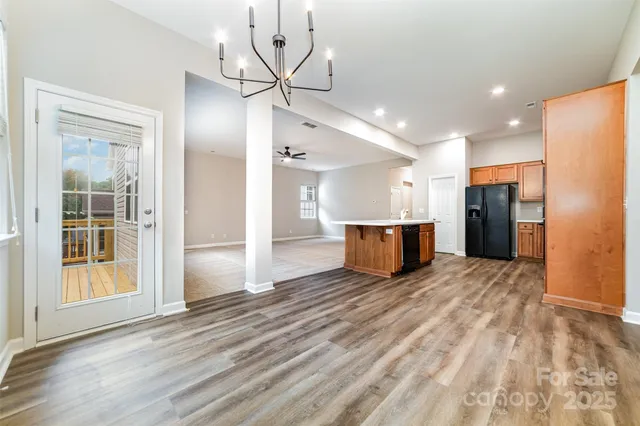 a view of kitchen with refrigerator and window