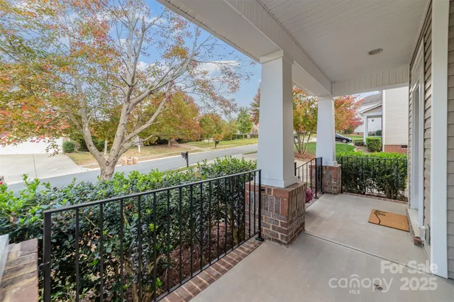 a view of a porch with wooden floor and fence