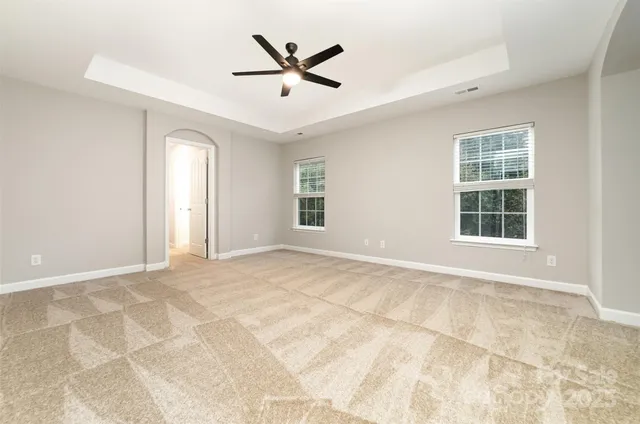 a view of a livingroom with a ceiling fan and window