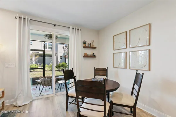 a view of a dining room with furniture and a window