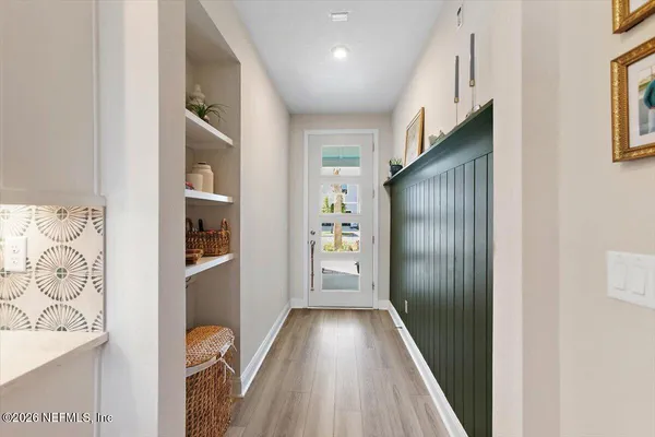 a view of hallway with wooden floor