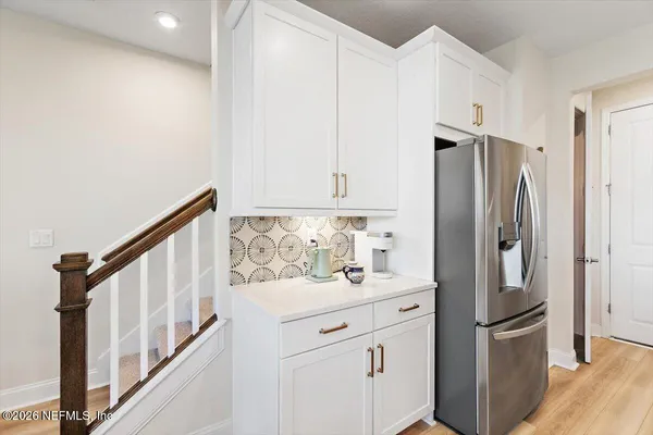 a kitchen with stainless steel appliances a refrigerator sink and microwave