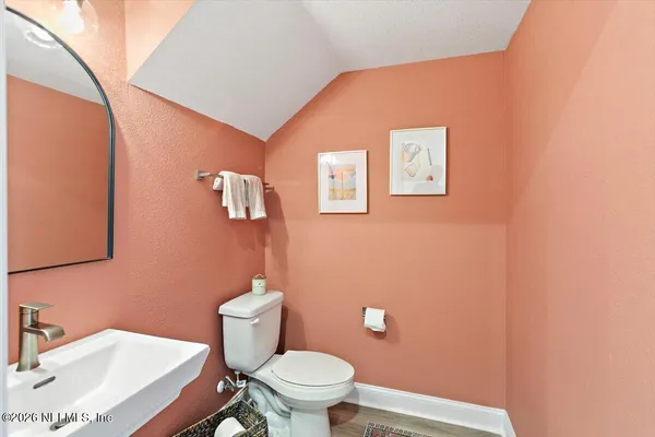 a bathroom with a sink a toilet and mirror