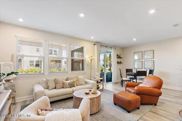 a living room with furniture and large windows