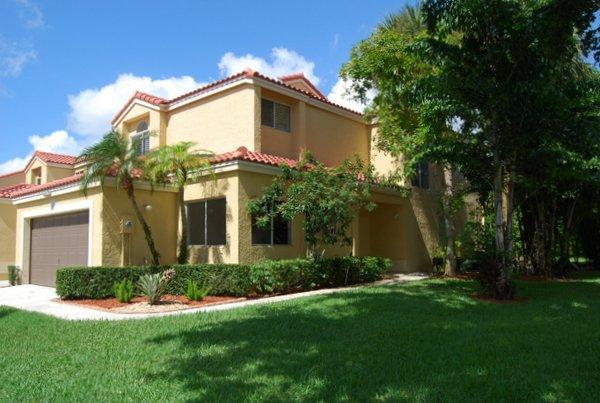 10473 Lake Vista Circle Boca Raton, FL 33498 - Photo 2 of 22 a view of a house with a small yard and large trees