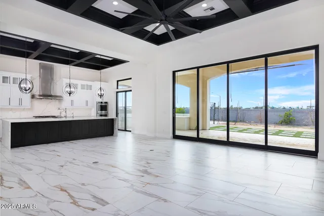 a view of kitchen with refrigerator and cabinets