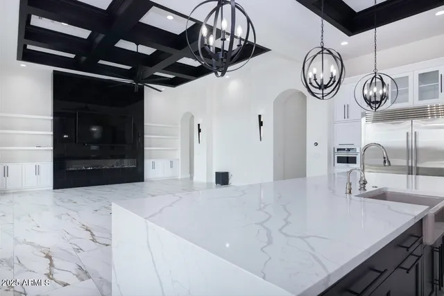 a kitchen with stainless steel appliances granite countertop a sink and cabinets