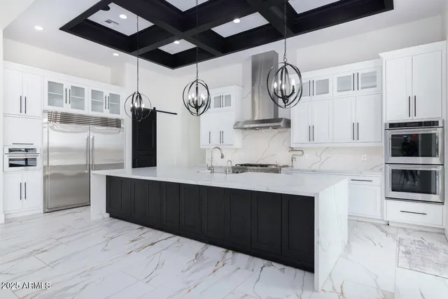 a view of a room with windows and chandelier fan