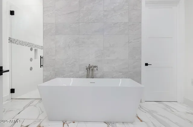 a room with walk in closet with empty racks