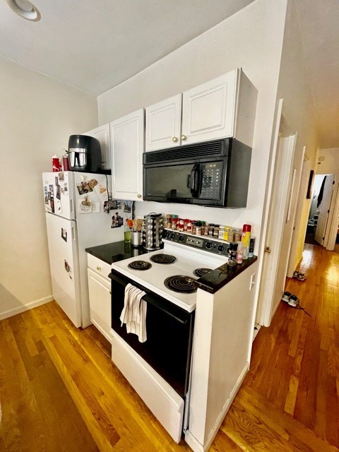 17 Thacher Street, Unit 3 Boston, MA 02113 - Photo 9 of 24 a kitchen with stainless steel appliances a stove a microwave and a refrigerator