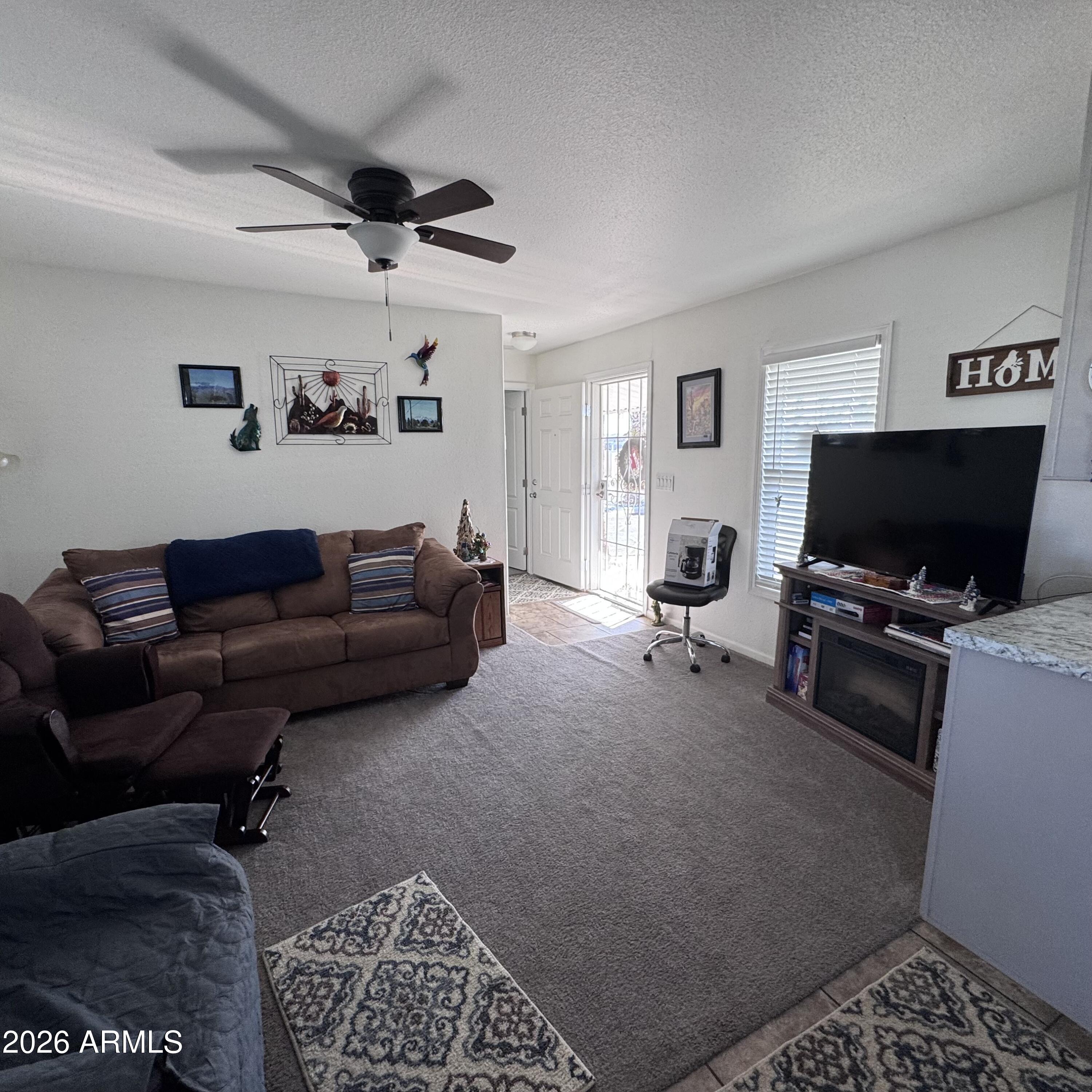 10540 East Apache Trail, Unit 15 Apache Junction, AZ 85120 - Photo 2 of 10 a living room with furniture and a flat screen tv