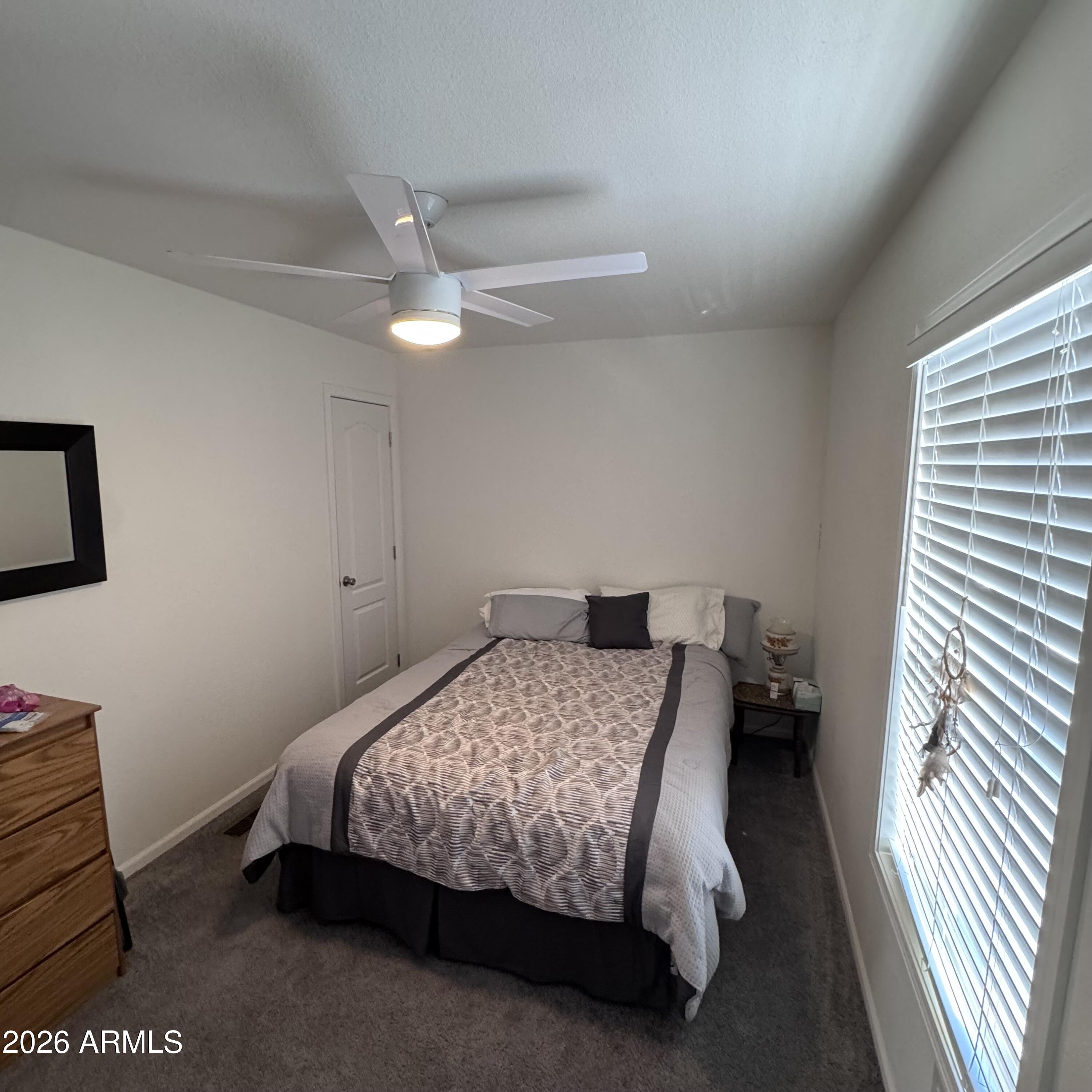 10540 East Apache Trail, Unit 15 Apache Junction, AZ 85120 - Photo 6 of 10 a bedroom with a bed and a chandelier