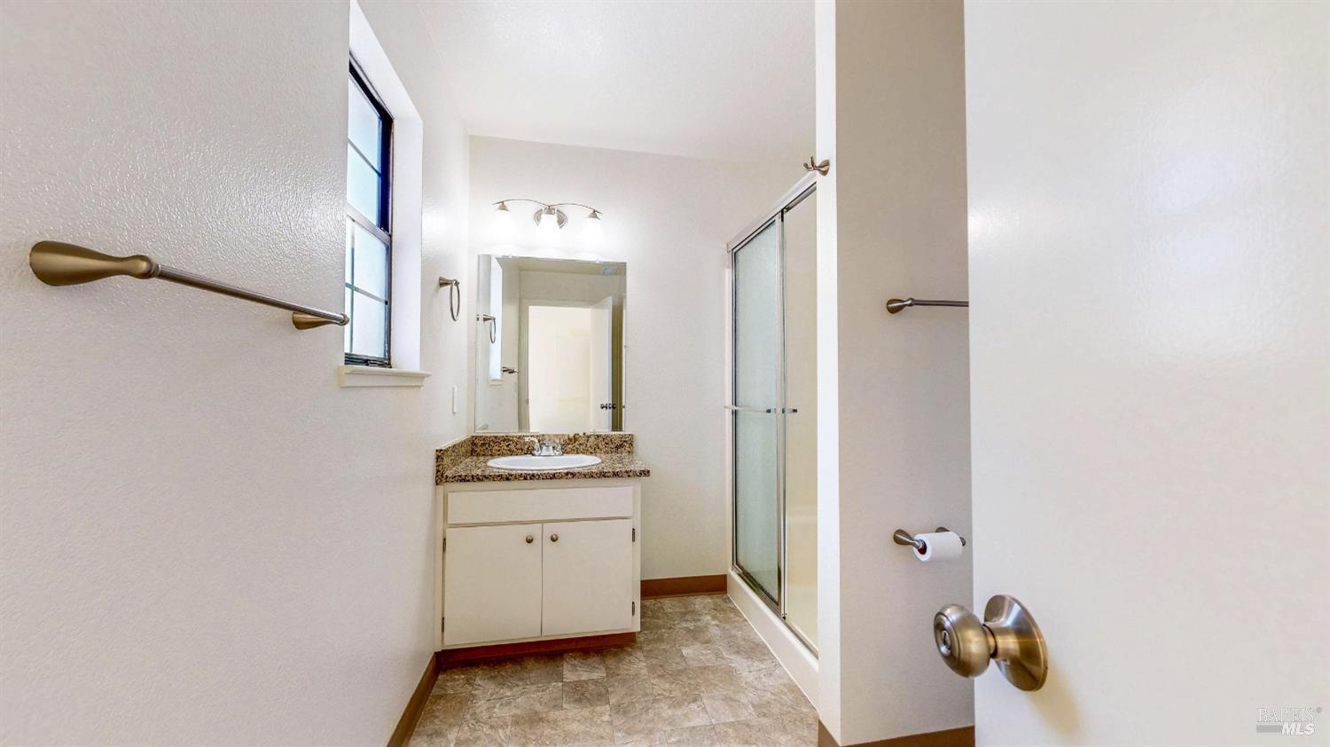 158 North Dutton Avenue Santa Rosa, CA 95401 - Photo 33 of 50 a bathroom with a granite countertop sink and a mirror