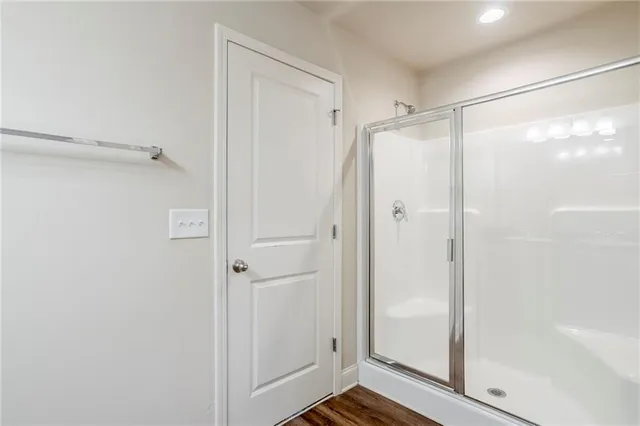 a bathroom with a glass shower door