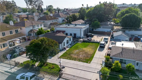 a view of a patio with couches table and chairs and potted plants