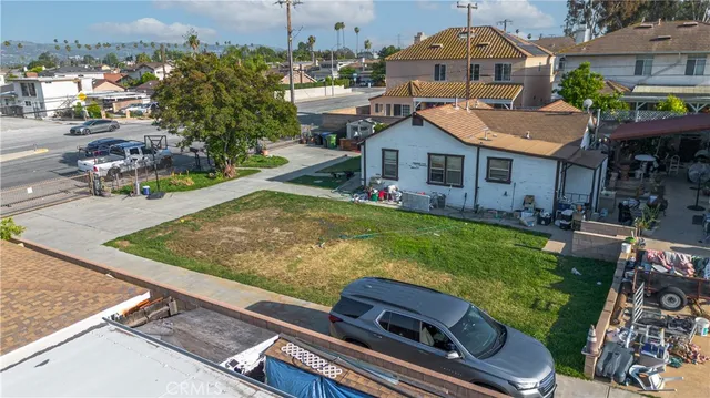 a view of a patio with couches table and chairs and potted plants