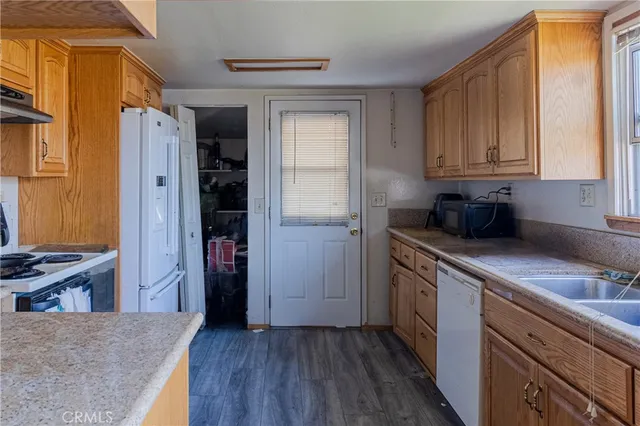 a kitchen with a refrigerator sink and cabinets