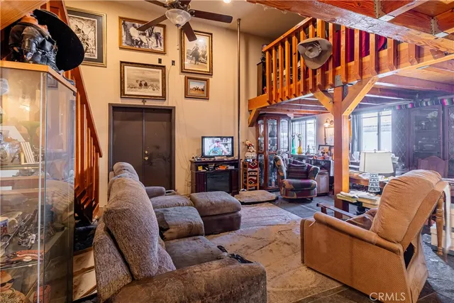 a living room with furniture a mirror and a chandelier