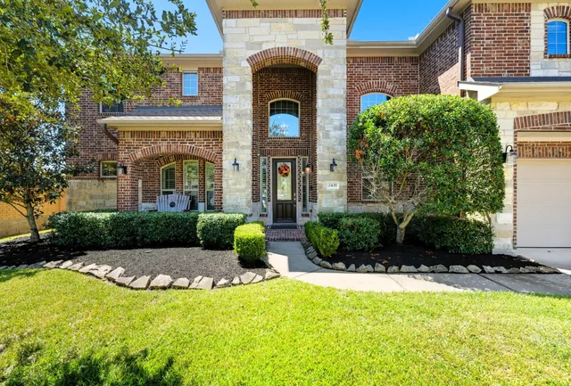 a front view of a house with garden