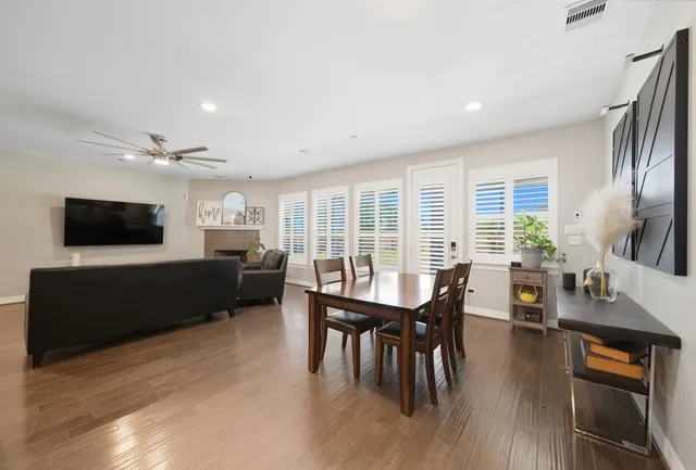 a living room with furniture wooden floor and a flat screen tv