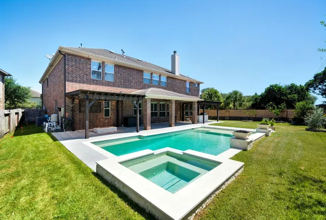 a view of a house with a yard and sitting area