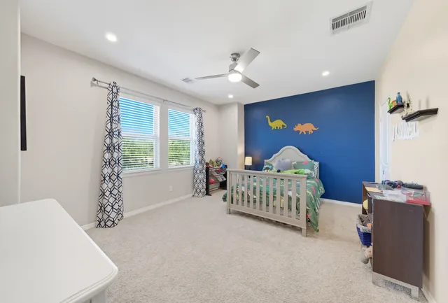 a bedroom with furniture and a large window