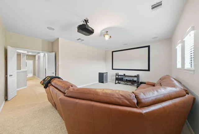 a living room with furniture and a ceiling fan