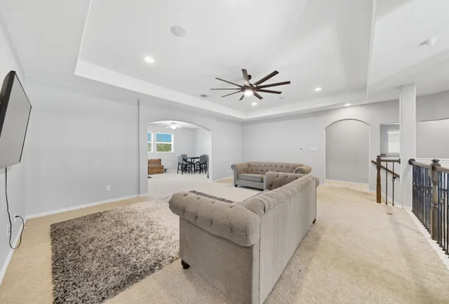 a dining room with furniture and a chandelier