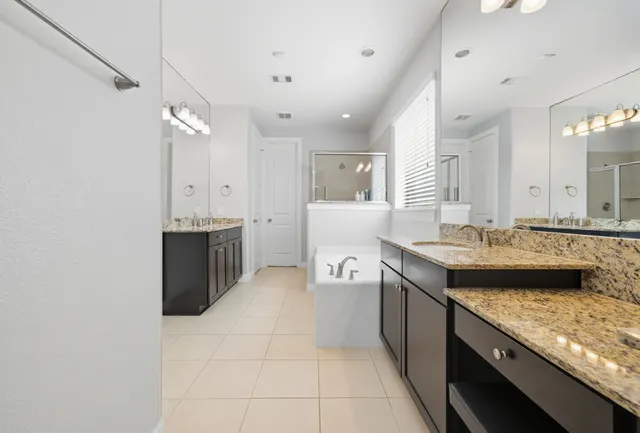 a bathroom with a tub sink and mirror