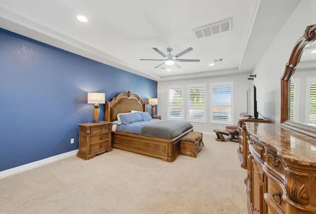 a bedroom with furniture and a large window