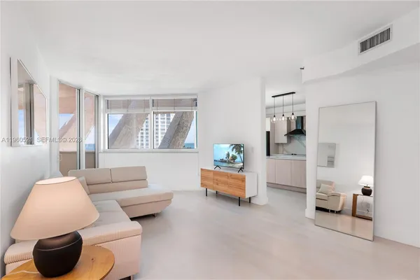 a living room with furniture and a large window