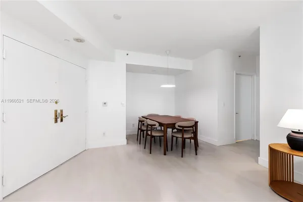 a dining room with furniture and chandelier
