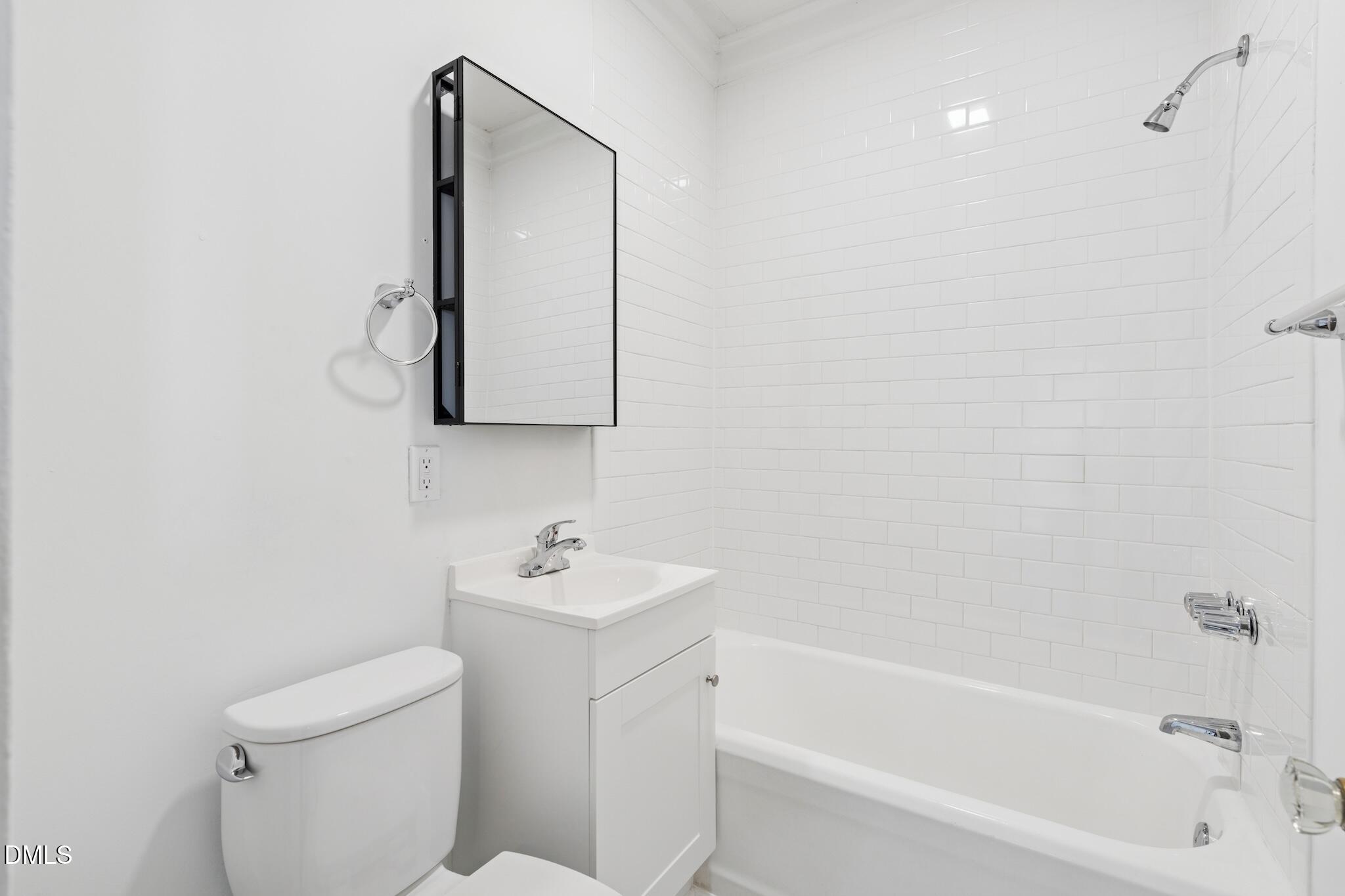 705 North Driver Street Durham, NC 27703 - Photo 16 of 46 a bathroom with a toilet sink and mirror
