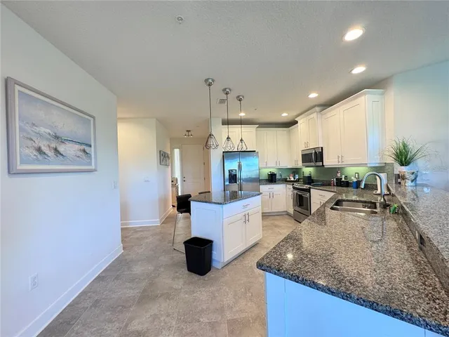 a kitchen with counter top space cabinets and stainless steel appliances