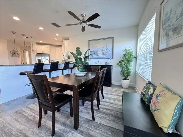 a view of a dining room with furniture and a potted plant