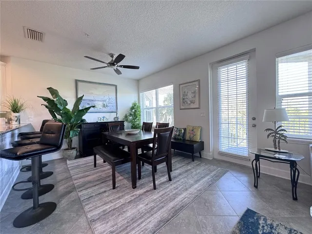 a living room with furniture a window and a potted plant