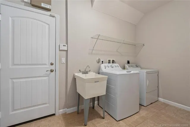 a utility room with sink dryer and washer