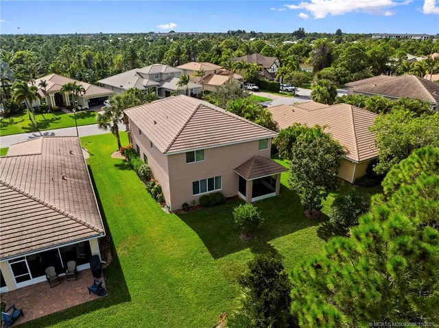 an aerial view of multiple houses with yard