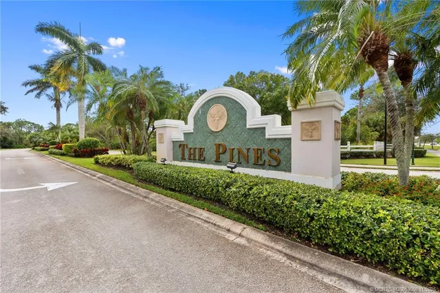a front view of a house with a yard and fountain