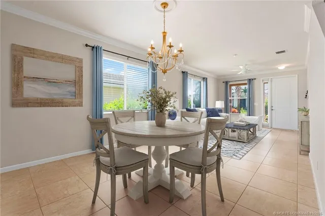 a view of a dining room with furniture and a chandelier