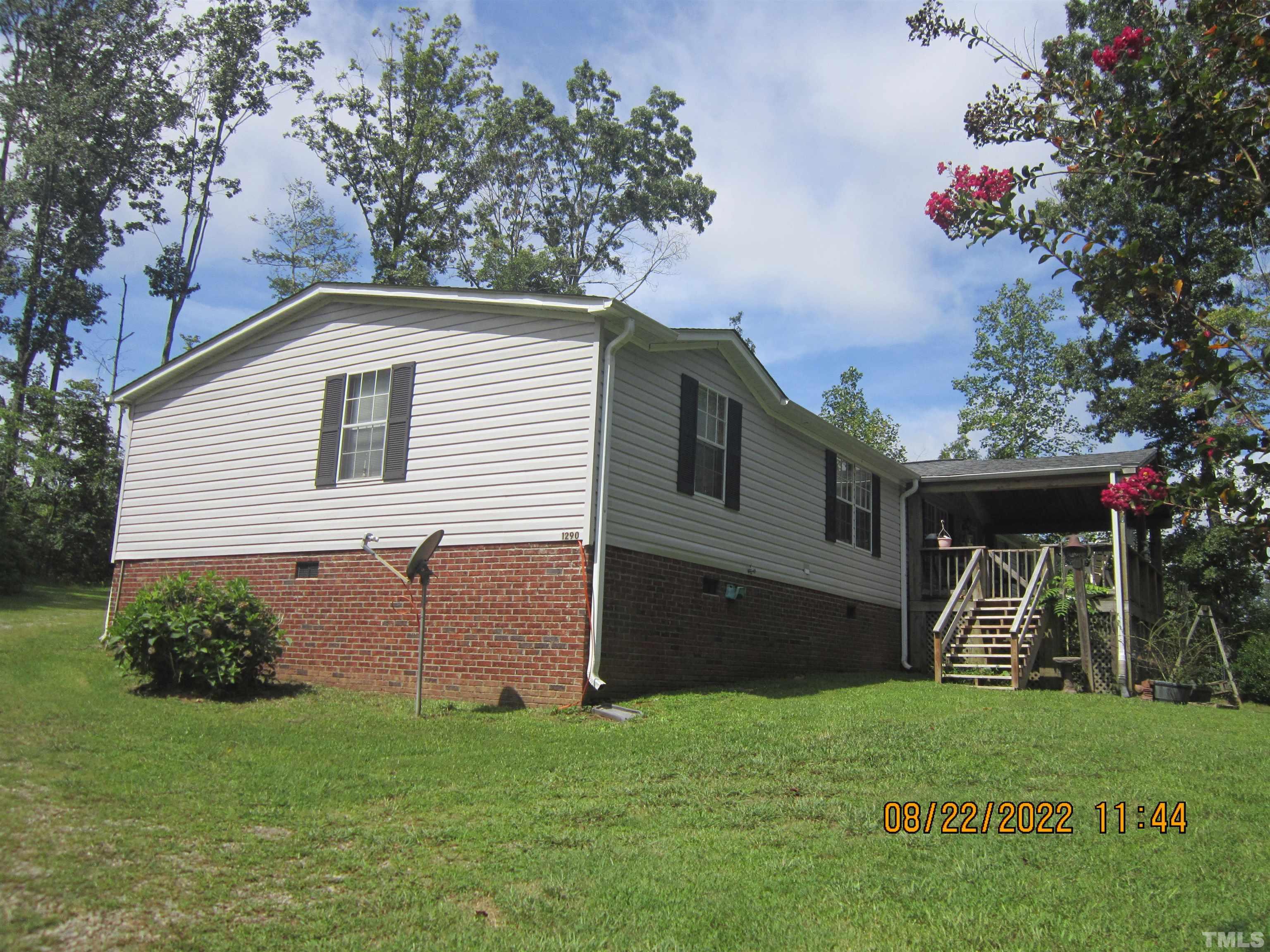 1290 Mann Oakley Road Rougemont, NC 27572 - Photo 4 of 29 a front view of a house with a yard