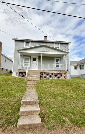 a front view of a house with a yard