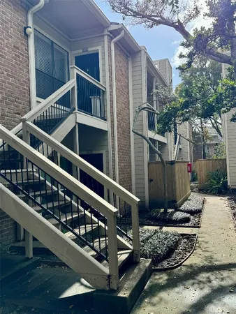a view of balcony with wooden floor and fence