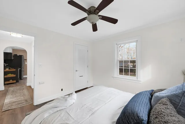 a bedroom with a large bed and a window