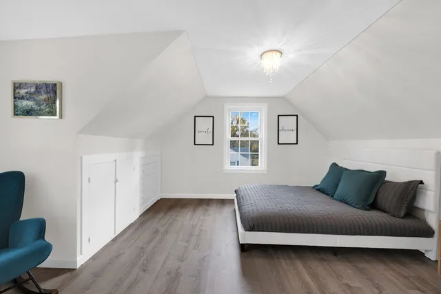 a bedroom with a bed and a chair